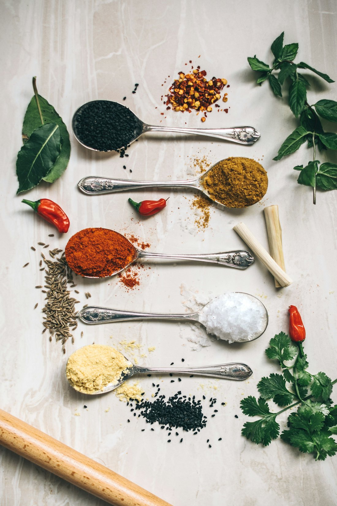 Spoons of ground spices — chilli, cumin and blends